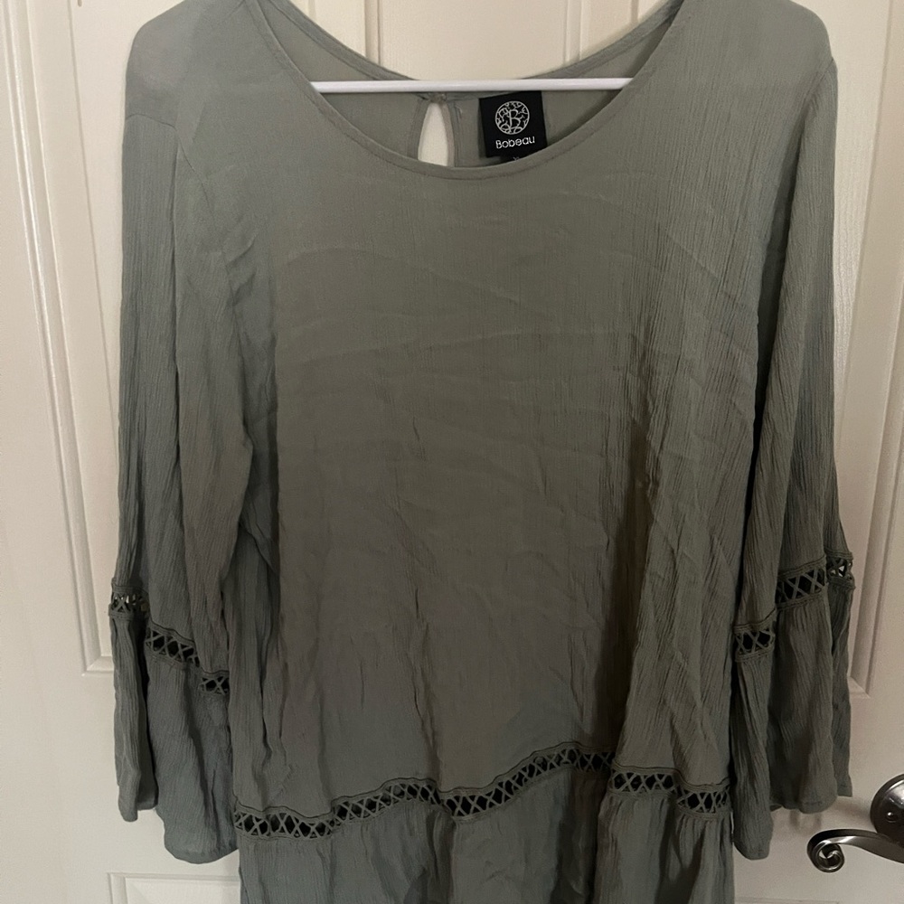long/half sleeve dark green flowy shirt with design at the bottom